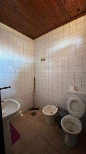 a bathroom with a toilet and a sink at Punto Clave in Posadas +49 photos