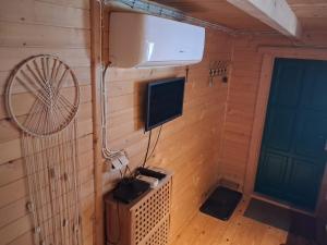 an inside view of a room with a television and a fan at Domek za lasem in Laskowa