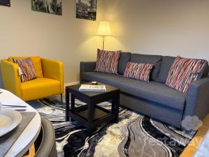 a living room with a couch and a table at restaway at Hamilton in Doncaster