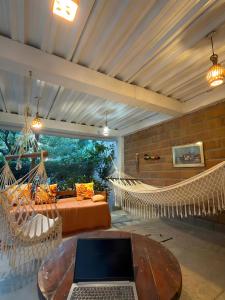 a room with a hammock and a laptop on a table at Casa Tara in Taganga