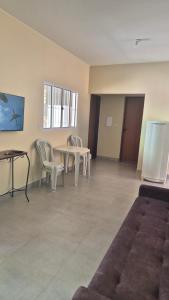 a room with a table and chairs and a couch at Chácara Anna Julia in Piedade