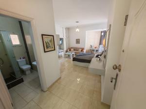 a bathroom and a living room with a bed and a sink at Avrio Red Sea in Hurghada