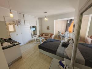 a bedroom with a bed and a living room at Avrio Red Sea in Hurghada