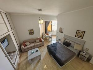 an overhead view of a living room with a bed and a couch at Avrio Red Sea in Hurghada