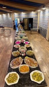 a long table filled with many plates of food at Sunrise Luxury Camp in Wadi Rum