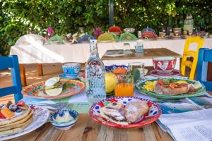 a wooden table with plates of food on it at Rosaria casaventre in Vietri sul Mare