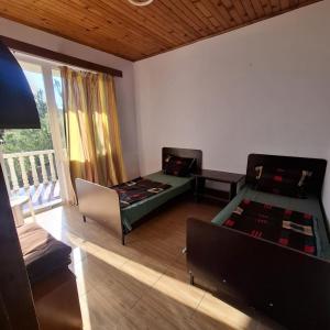 a living room with a bed and a couch at Large house at the beach. in Grigoleti