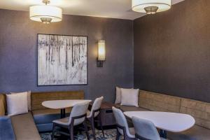 a waiting room with two tables and chairs at Residence Inn Worcester in Worcester