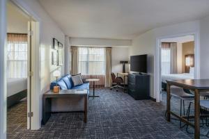 a hotel room with a bed and a living room at Residence Inn Worcester in Worcester +19 photos