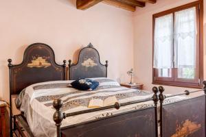 an antique bed in a room with a window at La Locanda di Diogene in Case Reggiani