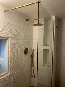 a shower with a glass door in a bathroom at Porta Blu Apulia in Martina Franca +27 photos