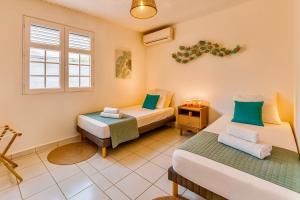 a room with two beds and a window at La villa Yuna in Le Vauclin +20 photos