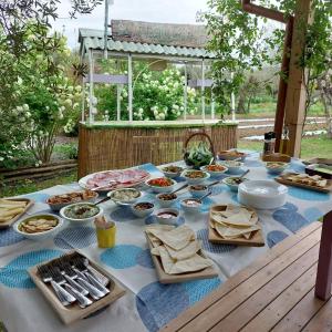 a table with many plates of food on it at Orto delle Fate in Marta +77 photos