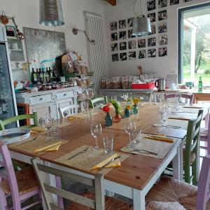 a table with wine glasses on it in a kitchen at Orto delle Fate in Marta