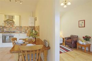 a kitchen and a living room with a dining room table at 1 Bed in Beccles oc-hfc in Wangford