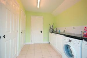 a laundry room with a washer and dryer at 1 Bed in Beccles oc-hfc in Wangford +2 photos
