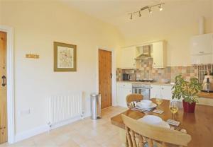a kitchen with a wooden table and a dining room at 1 Bed in Beccles oc-hfc in Wangford