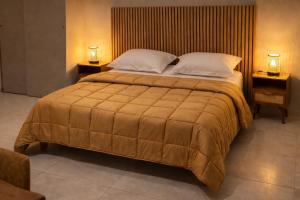 a bedroom with a large bed with two lamps on both sides at Château Gombert in Marseille