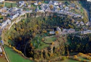 an aerial view of a small town with houses and trees at La maison bleue avec une grande piscine chauffée in Bozouls