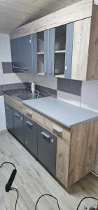 a kitchen with blue cabinets and a counter top at Cabana Relax in Râmnicu Vâlcea