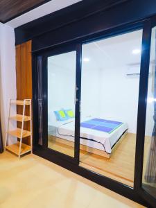 a room with a window with a bed and a ladder at Pickle n Pod villa in Solo with pickle court near mall in Grogol