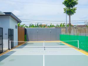 a tennis court with a net on top at Pickle n Pod villa in Solo with pickle court near mall in Grogol
