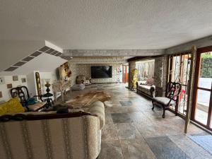 a large living room with couches and a tv at CasaButique in Mexico City