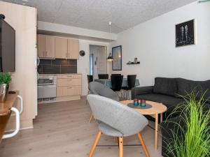 a living room with a couch and a table at 4 person holiday home on a holiday park in Ringkøbing