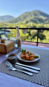 a table with a plate of food on a table at Minca Seasons Birds in Minca +31 photos