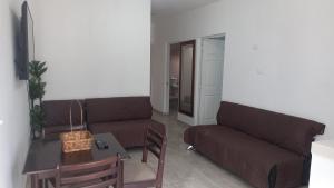 a living room with a couch and a table at Spacious house near the beach in Mazatlán +2 photos