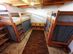 a room with three bunk beds in it at Habibi Hostel in Taghazout +68 photos