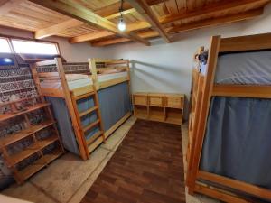 a room with two bunk beds in a room at Habibi Hostel in Taghazout