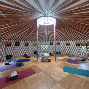a room with a large yurt with yoga mats at Orto delle Fate in Marta