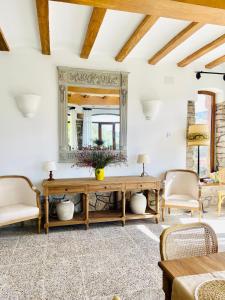 a living room with a table and chairs and a mirror at El Torreón de Cepones in Segovia