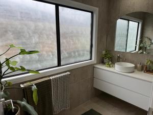 a bathroom with a sink and a window at SAND Haus in North Haven +12 photos