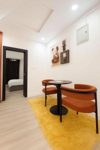 a room with a table and a chair and a bed at Gift cozy 1 bedroom in Lekki +2 photos