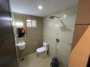 a bathroom with a toilet and a sink at Nellarachal Homestay in Ambalavayal +7 photos