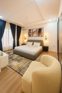 a large bedroom with a bed and a couch at Gift cozy 1 bedroom in Lekki