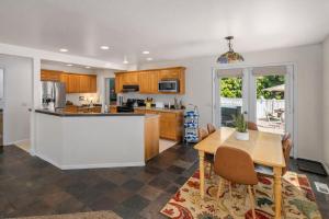 a kitchen and dining room with a table and chairs at All Seasons Getaway in Leavenworth +48 photos