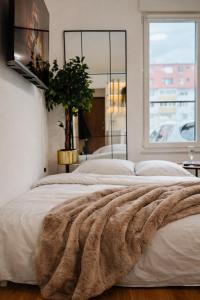 a bedroom with a large bed with a large window at SOL LUX Tuzla in Tuzla