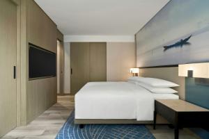 a bedroom with a large white bed and a television at Courtyard by Marriott Danang Han River in Danang +58 photos