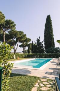 a swimming pool in a yard with trees at La Vecchia cantina Guzzardi in Lari