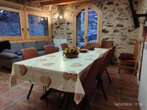 a dining room with a table and chairs at Cal RAFELÓ in Queralbs +7 photos