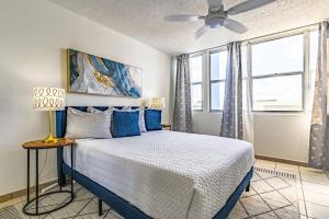 a bedroom with a large bed with blue pillows at Stylish Beach Condo ,1BR , City View Escape in San Juan +28 photos
