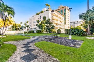 a picnic table in a park with buildings at Stylish Beach Condo ,1BR , City View Escape in San Juan
