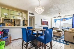 a kitchen and living room with a table and chairs at Stylish Beach Condo ,1BR , City View Escape in San Juan