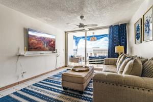 a living room with a couch and a table at Stylish Beach Condo ,1BR , City View Escape in San Juan