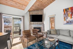 a living room with a couch and a fireplace at Woodbridge 29E in Snowmass Village +42 photos