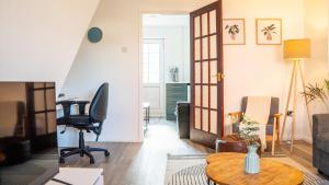 a living room with a table and a chair at 3BR House Near Cardiff Bay City Centre and Stadium with Free Parking in Cardiff