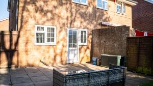 a brick house with a fence in front of it at 3BR House Near Cardiff Bay City Centre and Stadium with Free Parking in Cardiff